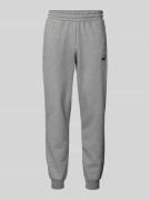 PUMA PERFORMANCE Sweatpants mit Logo-Stitching in Mittelgrau Melange, ...