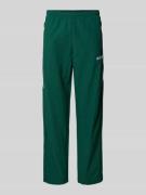 adidas Originals Sweatpants mit elastischem Bund in Dunkelgruen, Größe...